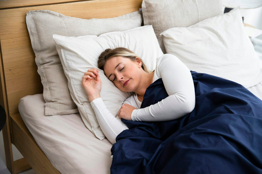 blnode woman sleeping under blue blanket