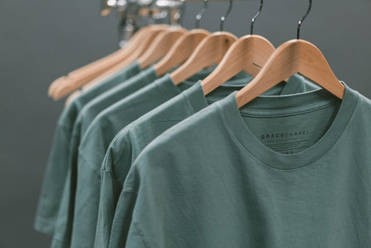 green POD t shirts hanging