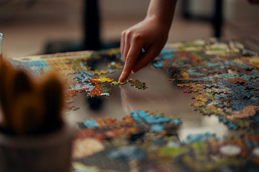 a person adjusting puzzle pieces