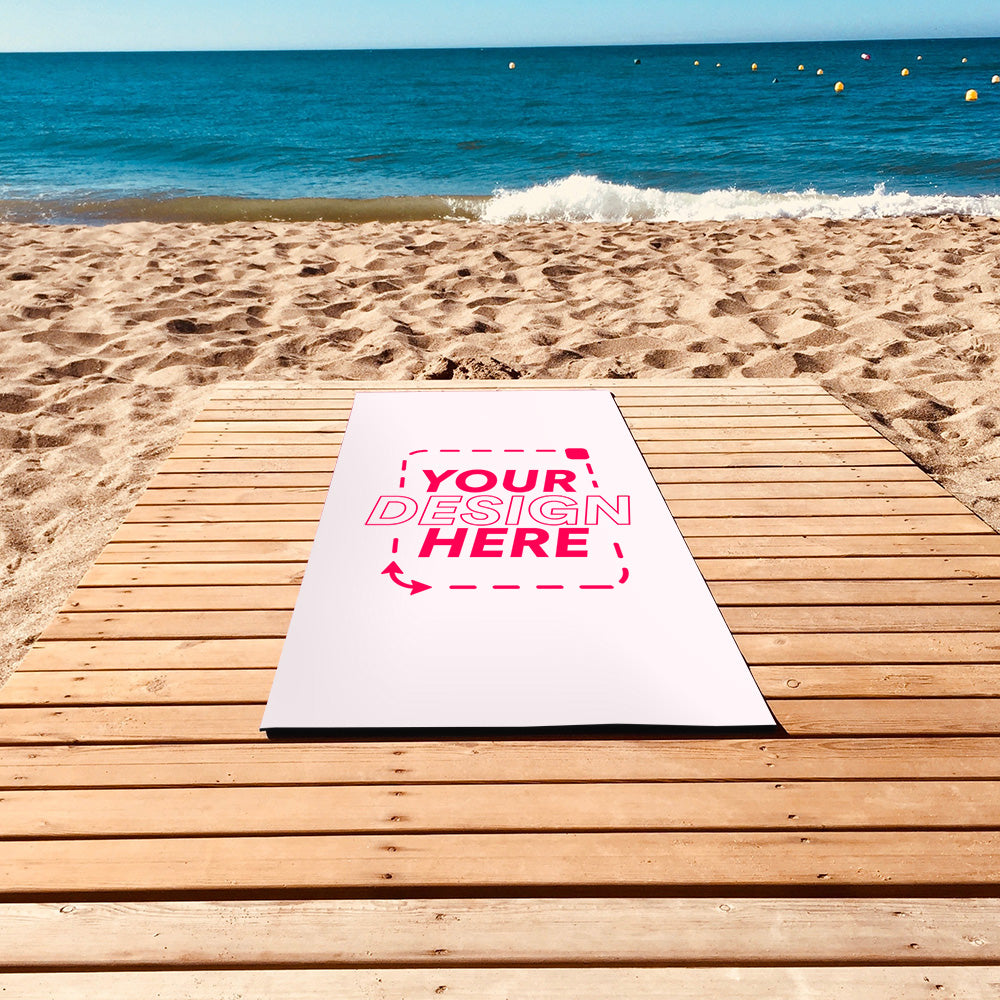 Custom yoga mat mockup on a wooden boardwalk by the beach, pink “Your Design Here” text, ideal for showcasing personalized or branded designs.