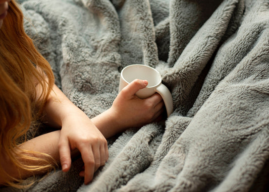 woman holding white mug