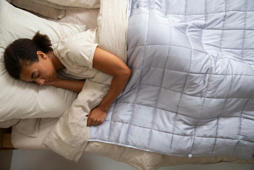 woman sleeping under light blue blanket