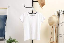 white print on demand shirt hanging with a hat