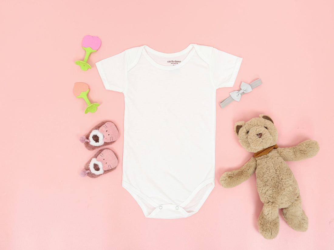 white onesies for babies with pink background