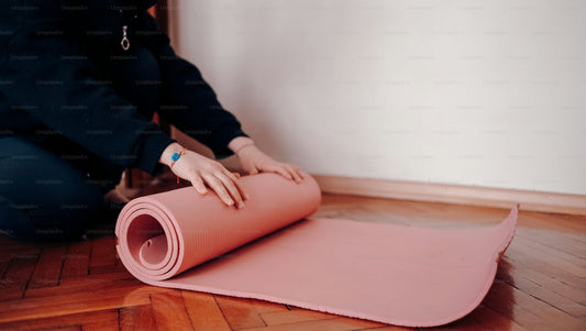 girl rolling pink yoga mat